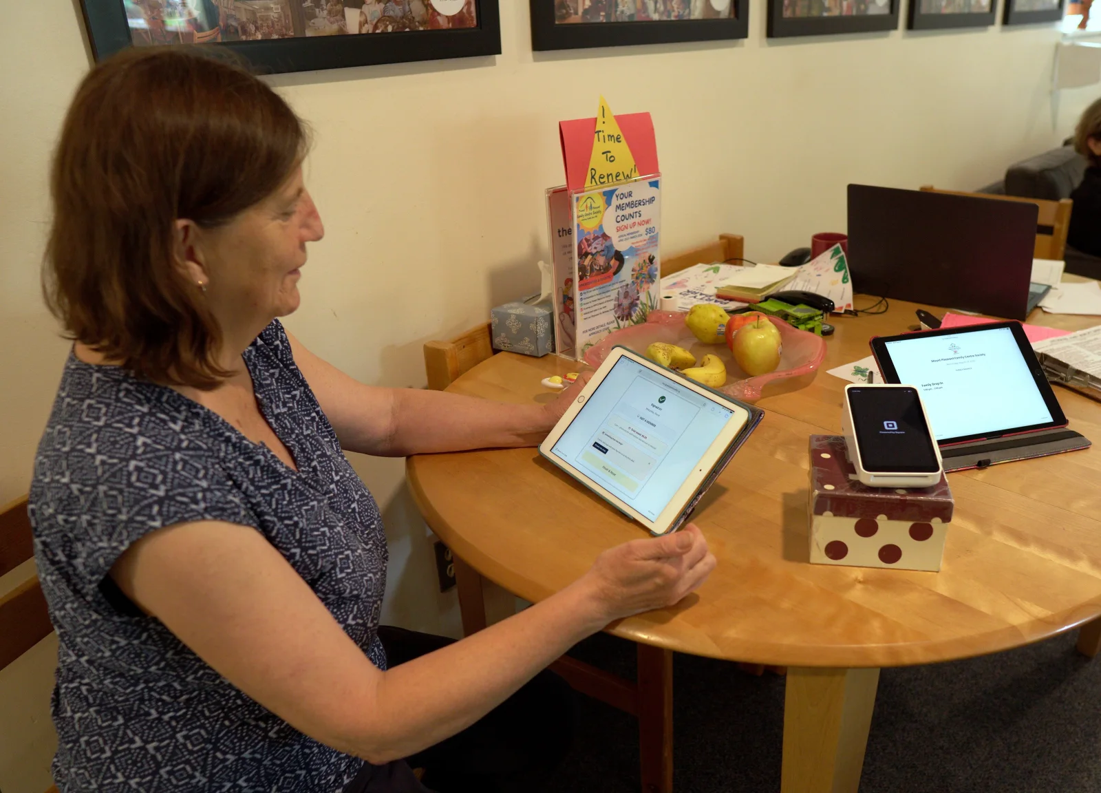A community member signing in on a tablet kiosk at Mount Pleasant Family Centre