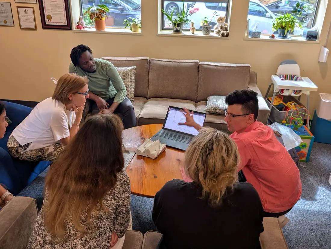 OpenCommunity staff training the Mount Pleasant team around a laptop